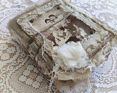 an old book covered in lace and flowers