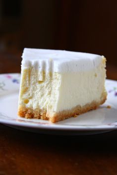 a piece of cheesecake sitting on top of a white plate with a bite taken out of it