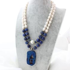 Beautiful handmade beaded Lapis Lazuli two strand necklace. Gorgeous cobalt druzy pendant, lapis lazuli round beads, freshwater pearls and brass and gold findings. perfect for any ocassion. Lenght is 19 inches. Handmade Elegant Lapis Lazuli Beaded Necklaces, Lapis Lazuli Gemstone Beads Pendant Jewelry, Blue Double Strand Natural Stones Jewelry, Blue Lapis Lazuli Jewelry, Beaded Lapis Lazuli Pendant Jewelry, Lapis Lazuli Beaded Pendant Jewelry, Druzy Pendant Necklace, Pearl Statement Necklace, Turquoise Crystal