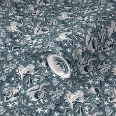 an image of a blue and white pattern with stars on the fabric, as well as a roll of toilet paper