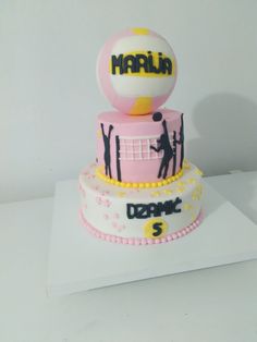 a three tiered cake with a volleyball theme on top