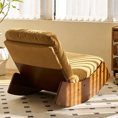 a chair sitting on top of a rug next to a window