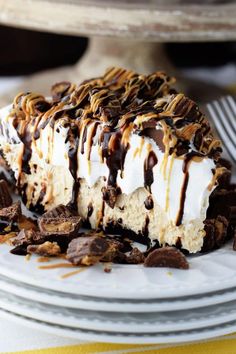 a piece of ice cream pie on a plate with chocolate chips and caramel drizzle