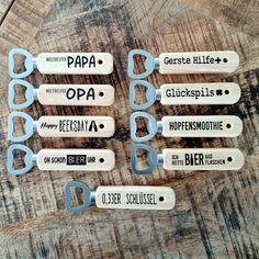 six beer bottle openers sitting on top of a wooden table