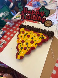 a birthday cake shaped like a slice of pizza