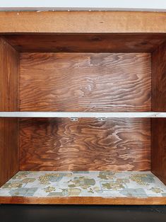 an empty wooden shelf with tile on the bottom and bottom shelves in between it's sides