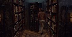 a man walking through a library filled with lots of books