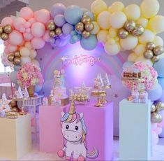 a unicorn themed birthday party with balloons and cake