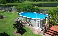 an above ground swimming pool with steps leading up to it and a ladder in the middle