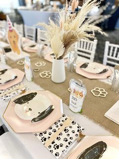 the table is set with plates, silverware, and napkins for an animal themed party