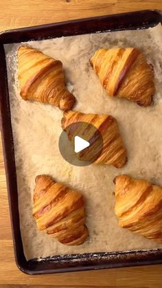 four croissants sitting on top of a baking pan