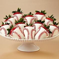 a white platter filled with strawberries on top of a table