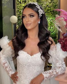 a woman in a wedding dress posing for the camera