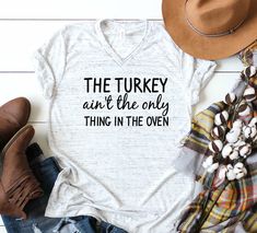 a t - shirt that says the turkey isn't the only thing in the oven