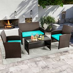 an outdoor patio furniture set with blue cushions and coffee table in front of a fire place