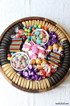 a wooden tray filled with candy and candies