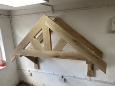 an unfinished wooden frame hanging from the ceiling