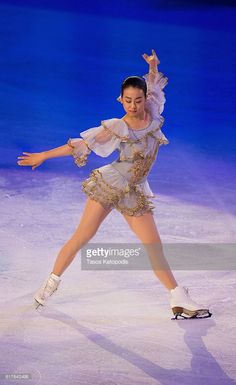 a female figure skating on an ice rink