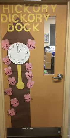 a door decorated with a clock and pink piggy poop decorations for the classroom