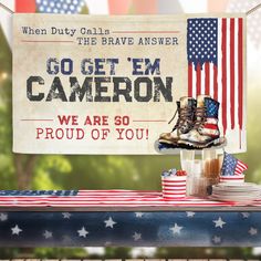 an american flag table with patriotic items and a sign that says go get'em cameon we are so proud of you