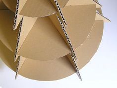 an origami sculpture made out of cardboard with scissors sticking out of the top