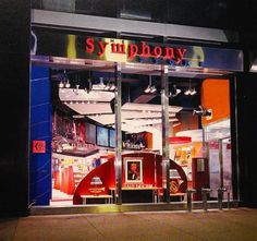 a store front with an assortment of items displayed in the window and lit up at night