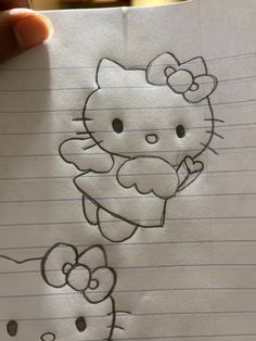 a drawing of a hello kitty holding a teddy bear on top of a piece of paper