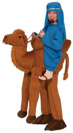 a man riding on the back of a camel wearing a blue robe and holding a stick