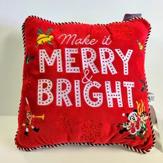 a red pillow that says make it merry and bright