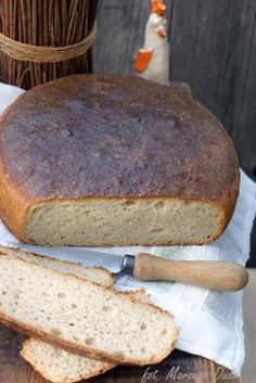 a loaf of bread sitting on top of a wooden cutting board next to a knife