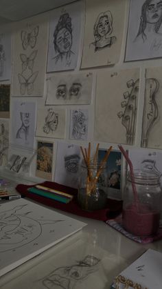 there are many drawings and pencils on the wall