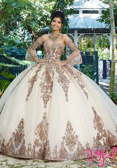 a woman in a ball gown posing for the camera