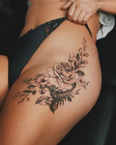 a woman's thigh with flowers on it