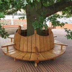 a wooden bench under a tree on a deck