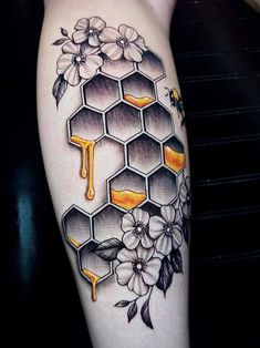 a tattoo with honey and flowers on it