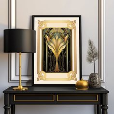 a black table with a gold lamp and art work on it