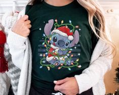 Buy Christmas Lilo & Stitch Christmas Lights Shirt Disney T-Shirts is designed & sold by DaniellWhite. SKU 38314955 listed on 11 09, 2022. Most ship worldwide within 24 hours. Delivery to the United States. Disney T Shirts, Stitch Christmas, Disney T, Lilo Stitch, Disney Tshirts, Lilo And Stitch, Christmas Tshirts, Types Of Shirts, Christmas Lights