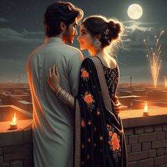 a man and woman standing next to each other on top of a roof at night