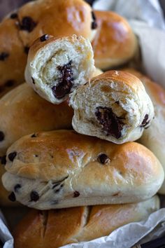 several rolls with chocolate chips on them sitting in a basket