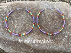 "Here's a pair of purple with native colors beaded hoop earrings that are lightweight and comfortable to wear all day long. Made with high quality glass Delica Beads, beaded one bead at a time. Love and passion goes into making my jewelry. This process requires focus, patience and dedication. Each bead is 16th of an inch and can take hours to complete a project. They are 2\" around.  They would be a great addition to your wardrobe. This would make a great gift for someone special or a treat for yourself. Handmade is from the Heart ❤️ Handmade in Arizona 🇺🇸 Thank you for stoping by.  Have a great day." Purple Heishi Bead Jewelry With Colorful Beads, Adjustable Small Purple Hoop Earrings, Purple Bohemian Round Hoop Earrings, Bohemian Purple Round Hoop Earrings, Adjustable Purple Hoop Earrings, Purple Beaded Hoop Earrings With Round Beads, Adjustable Purple Round Hoop Earrings, Purple Beaded Round Hoop Earrings, Adjustable Nickel-free Purple Hoop Earrings