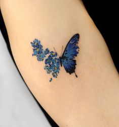 a blue butterfly with yellow dots on its wings