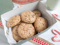 a box filled with cookies next to a glass of milk