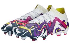 a pair of white and purple soccer shoes with colorful designs on the upper soles