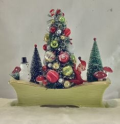 a small christmas tree in a wooden boat