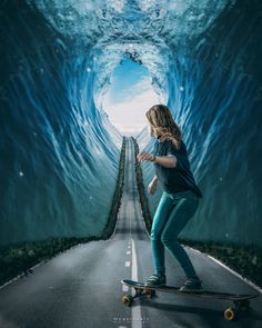 a woman riding a skateboard down a road under a tunnel filled with blue water