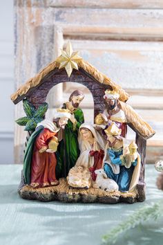 a nativity scene is displayed on a table