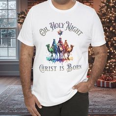 Oh Holy Night Christ is Born T-Shirt, Christmas Christian Gift, Nativity Scene Tee, Religious Holiday Shirt, Christmas Spiritual Apparel Celebrate the true meaning of Christmas with our "Oh, Holy Night, Christ is Born" T-Shirt. This tee features a beautiful, colorful, 3 Wise Men scene and a powerful message, making it a perfect gift for those who adore the spiritual essence of the holiday season. Ideal for Christmas parties, church gatherings, or casual wear, this shirt spreads joy and faith with every wear. Available in various sizes, it's comfortable, stylish, and meaningful. Product Features: Fabrication: 100% Airlume combed and ring-spun cotton, 32 single 4.2 oz. (Ash - 99% Airlume combed and ring-spun cotton, 1% poly) Seams: Side-seamed Fit: Retail Fit Sizing: Unisex Sizing Label: Tea For Unto Us A Child Is Born Shirt, Christmas Spiritual, Christ Is Born, Christmas Christian, Spiritual Clothing, Oh Holy Night, True Meaning Of Christmas, Christian Christmas, Holiday Shirt