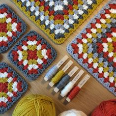 several crocheted squares and yarns on a table