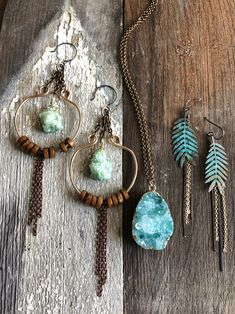 "Green druzy stones hang from hand made bronze hoops with wood bead adornments and copper chain. Hang from gold filled ear wires. Measurement: 6\"x1.5\" All of our items are HANDMADE and made to order and may take up to approx. 2 weeks to fabricate (not including shipping time). During the holiday season fabrication time might take up to 3 weeks. We are happy to expedite your shipping for an additional charge. Please contact us PRIOR to making your purchase so we can give you a shipping quote on Rustic Gold Dangle Jewelry, Bronze Copper Jewelry With Dangling Beads, Copper Jewelry With Dangling Beads, Handmade Rustic Brass Jewelry, Artisan Copper Wire Dangle Jewelry, Unique Copper Jewelry With Dangling Beads, Rustic Hand Wrapped Copper Jewelry, Patina Earrings, Fern Leaf