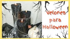 two candles are sitting in front of some fake pumpkins and trees with the words velones para halloween